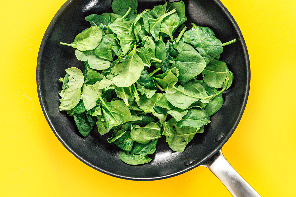 Spinach in a black saute pan