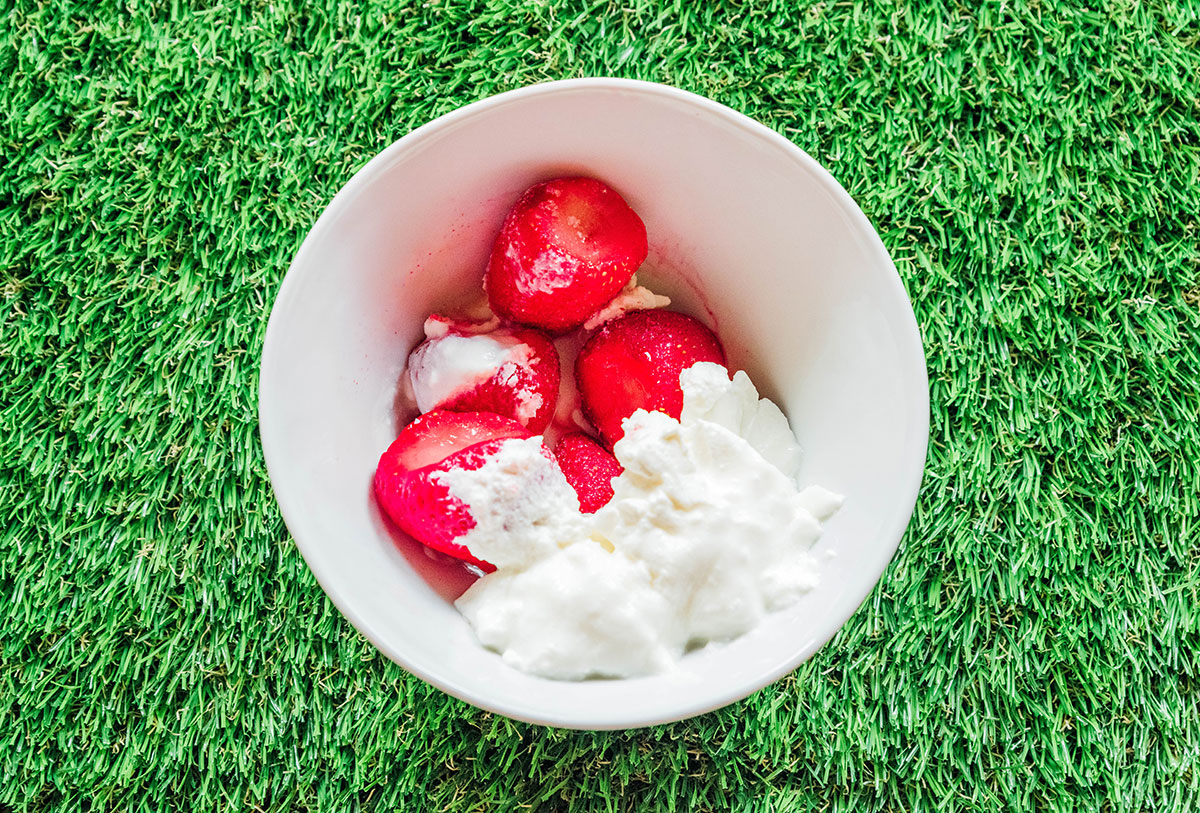 A bowl of strawberries and yogurt.