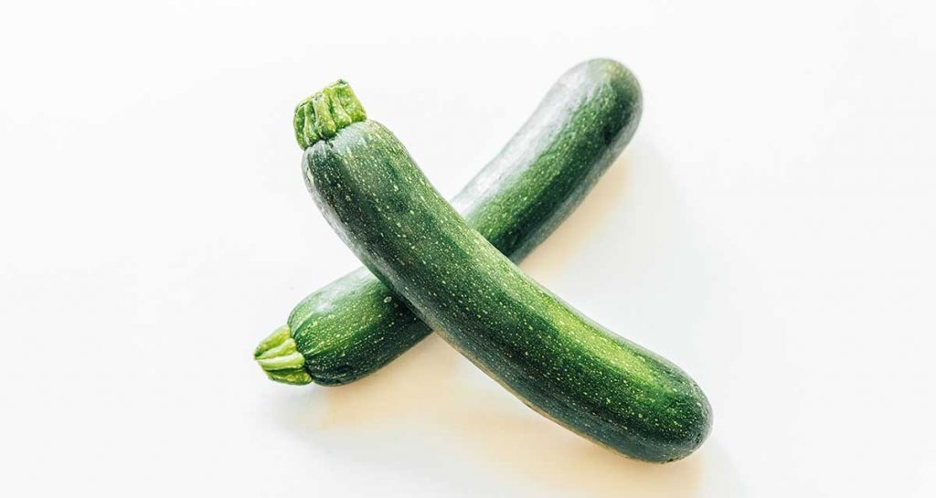 Two zucchinis on a white background