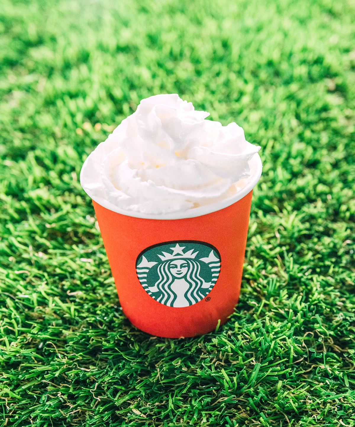 Whipped cream in a mini red starbucks cups.