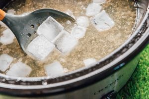 Cooling bone broth with ice cubes