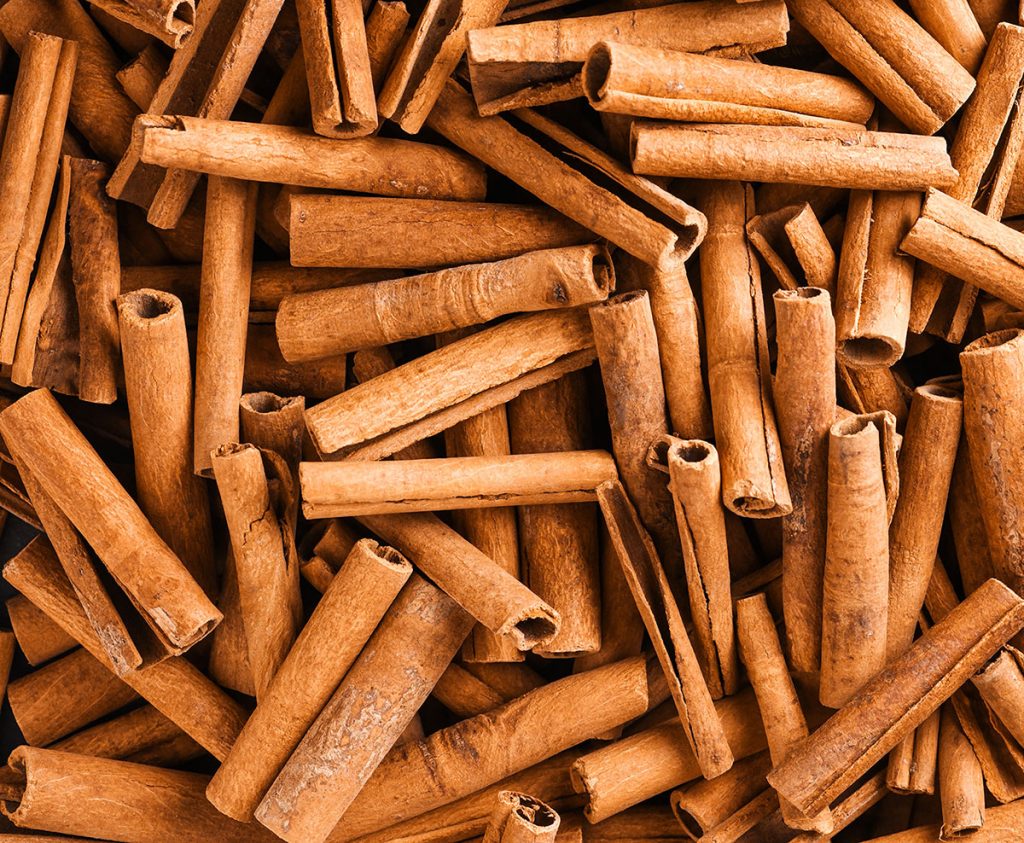 Lots of cinnamon sticks laid out.