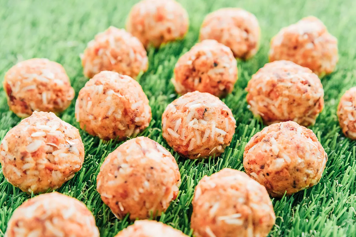 Sensitive dog treats shaped into balls on grass.