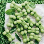 Bone shaped breath mints for dogs on grass.