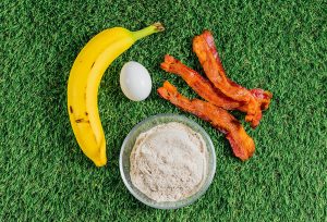 Ingredients for bacon dog treats on grass.