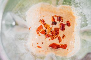 Bacon dog treat ingredients in a blender.