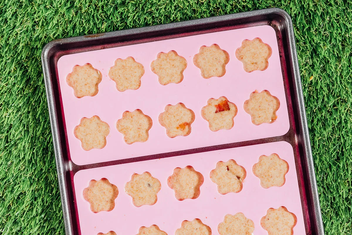 Bacon dog treats in paw shaped molds.