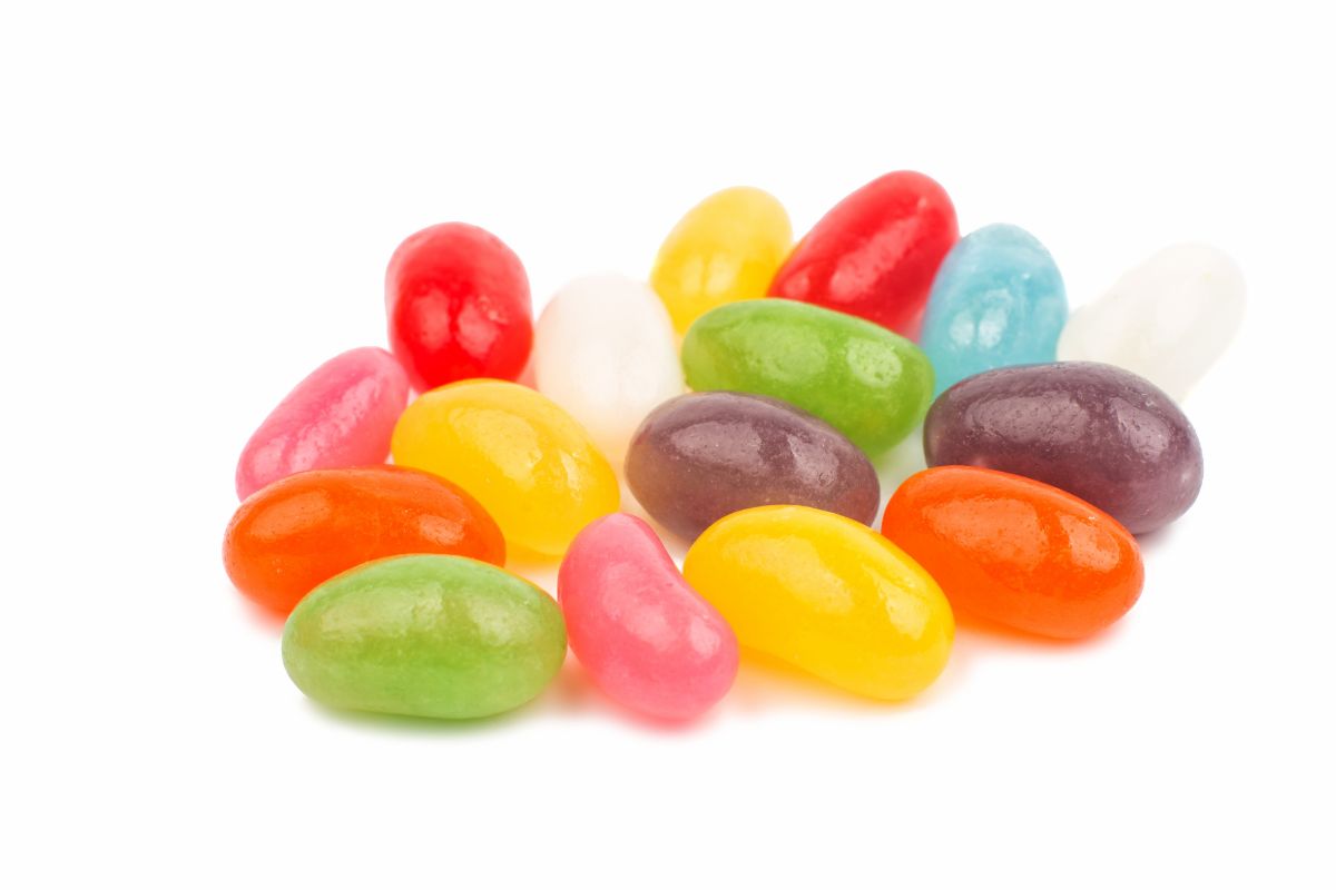 Multi-colored jelly beans on a white background.