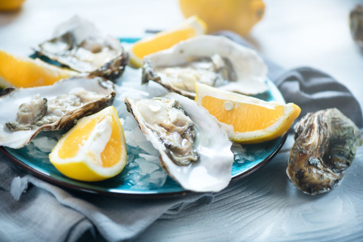 Oysters on a plate with lemon.