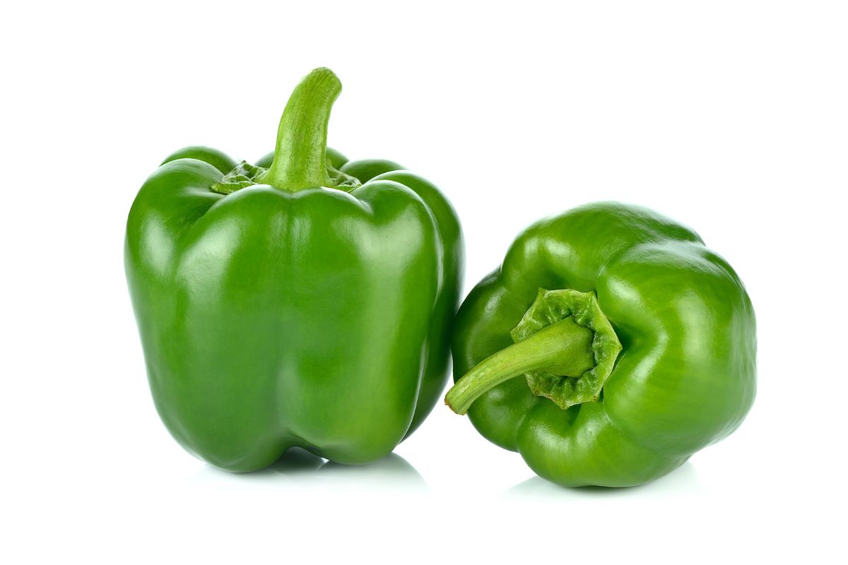 Green sweet peppers on a white background.